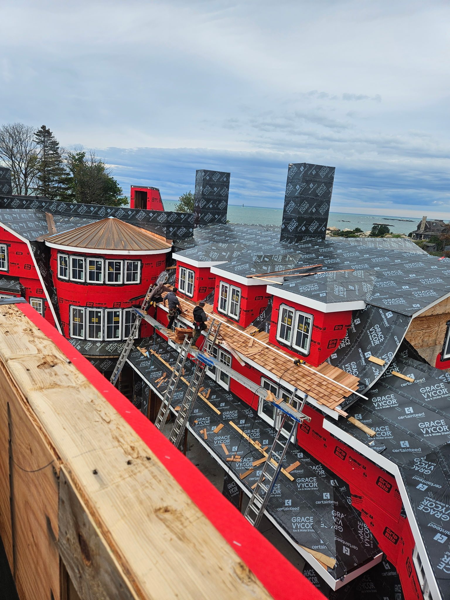 Roofing crew completing full roof replacement