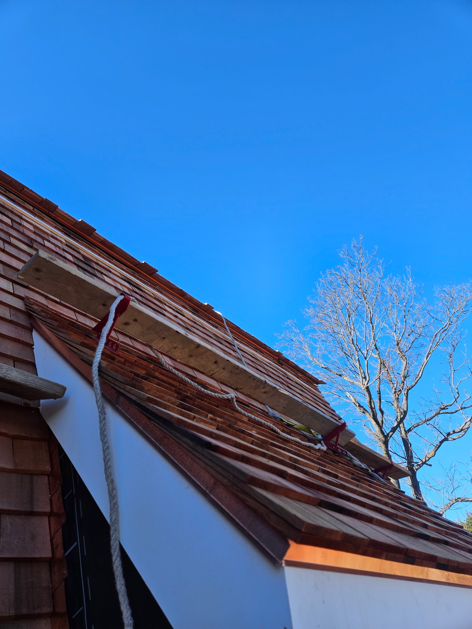 Leak repair and patched roofing section with matching shingles